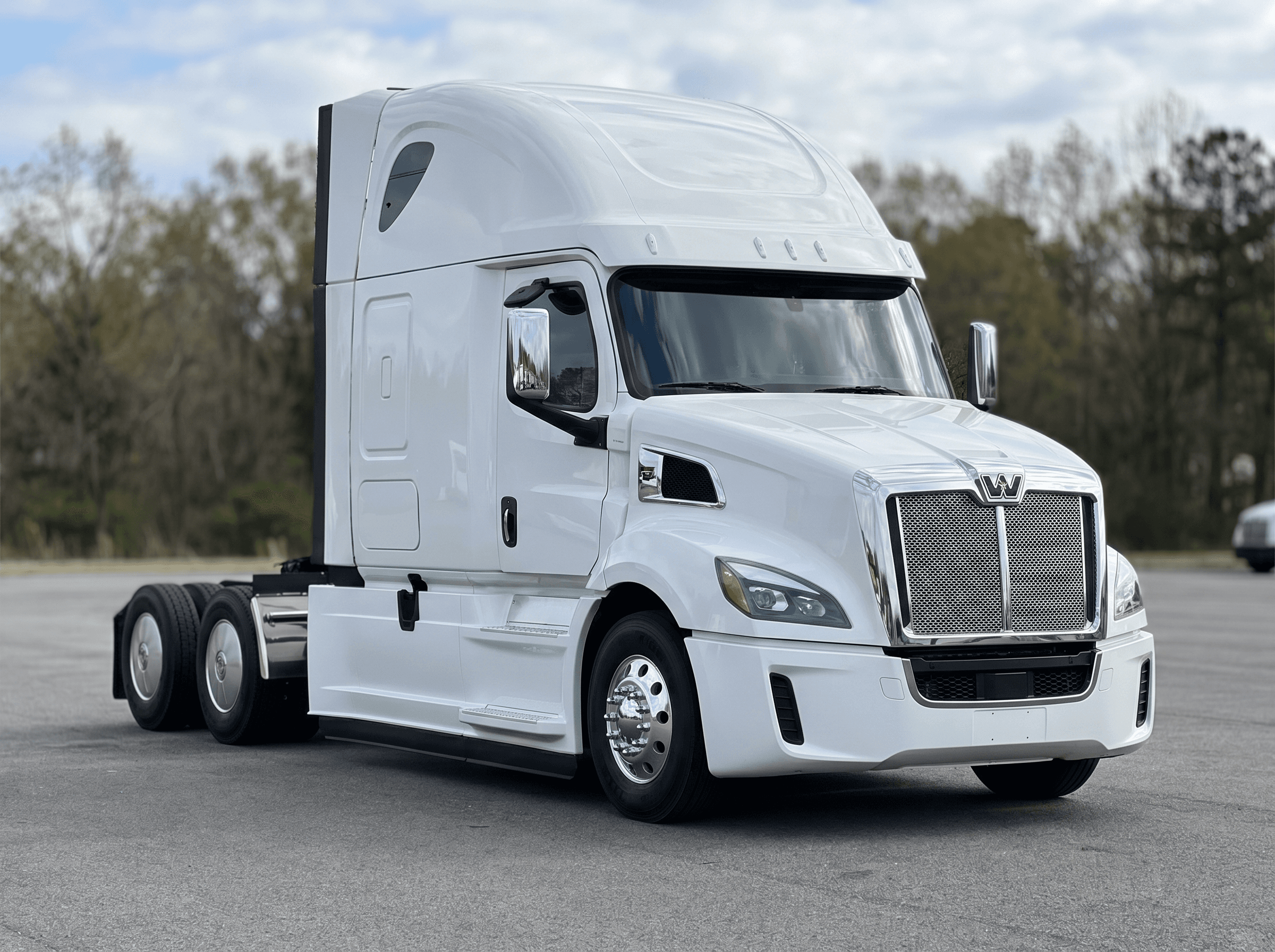 2024 Western Star 57X Stratosphere high-roof sleeper in white on a dealership lot