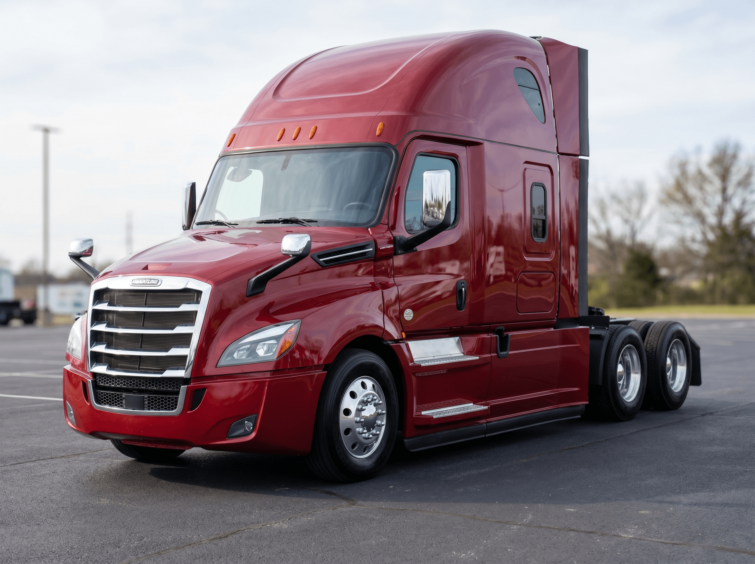 2018 Freightliner Cascadia 126 sleeper in deep red on a dealership lot